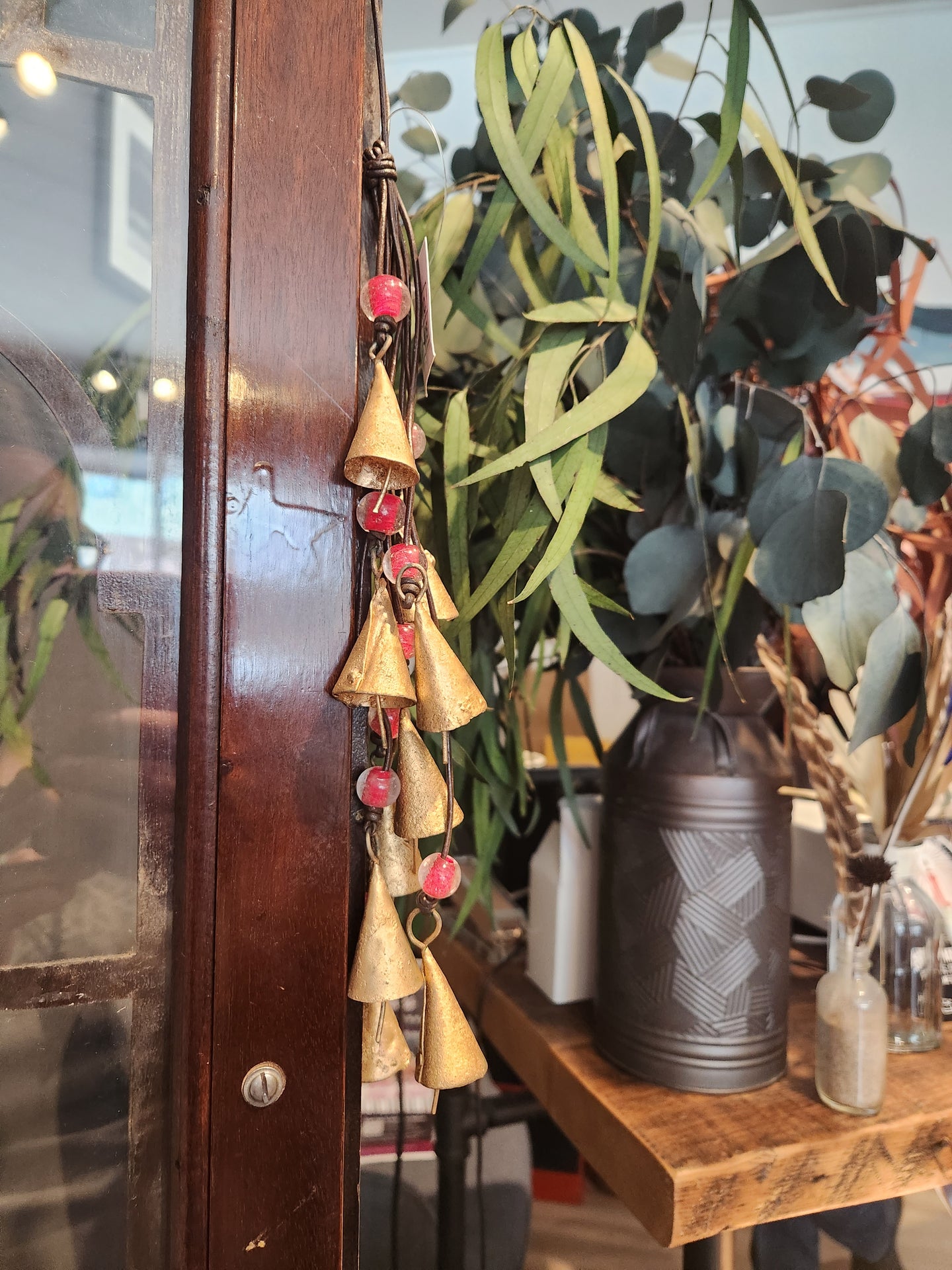 Mini bell Chimes with red beads on a leather strap